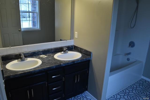 bathroom featuring vanity and shower / bath combination