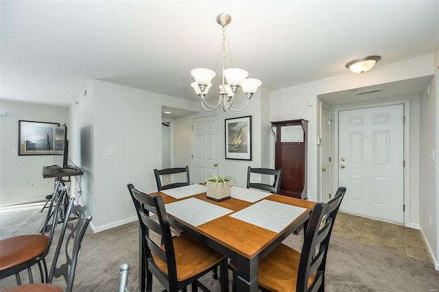 dining space featuring light carpet and a notable chandelier