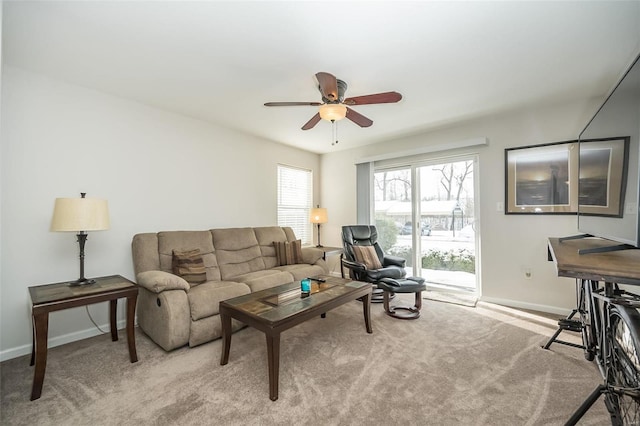 carpeted living room featuring ceiling fan