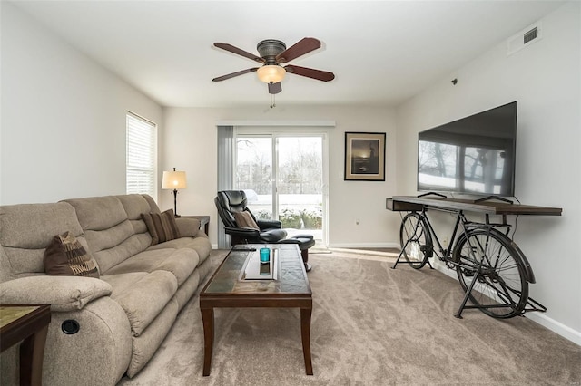 living room featuring ceiling fan and light colored carpet