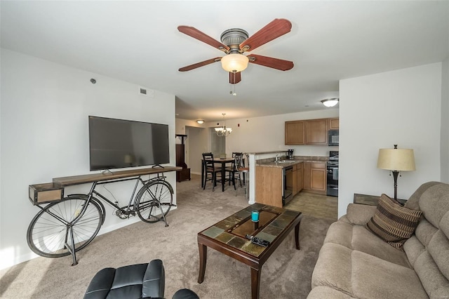 carpeted living room featuring ceiling fan with notable chandelier