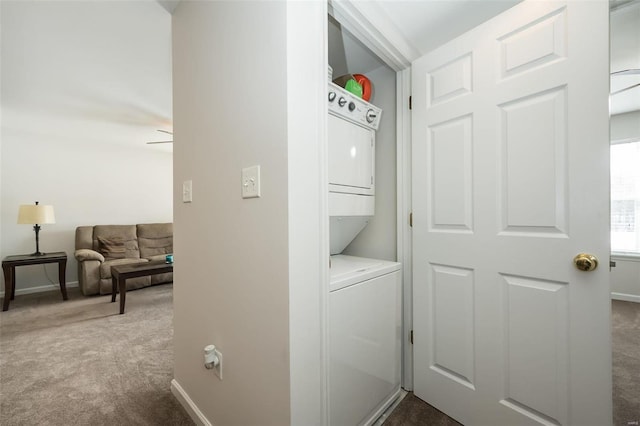 clothes washing area with ceiling fan, carpet floors, and stacked washer and dryer