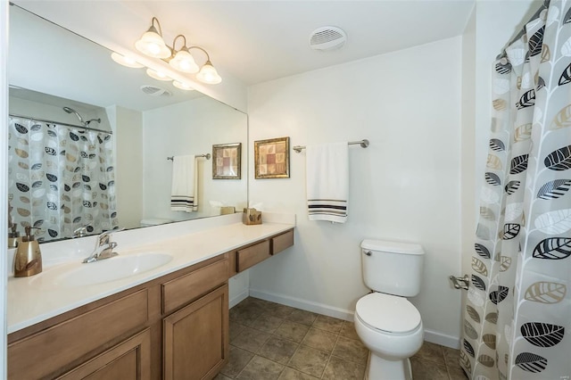 bathroom featuring vanity, toilet, and walk in shower