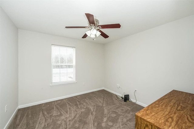 spare room with ceiling fan and carpet