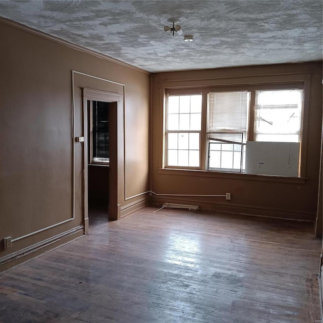 spare room featuring dark hardwood / wood-style floors and ornamental molding