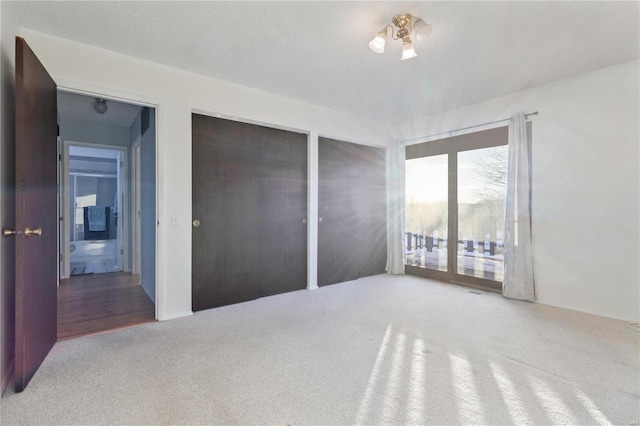 bedroom with a textured ceiling and carpet flooring