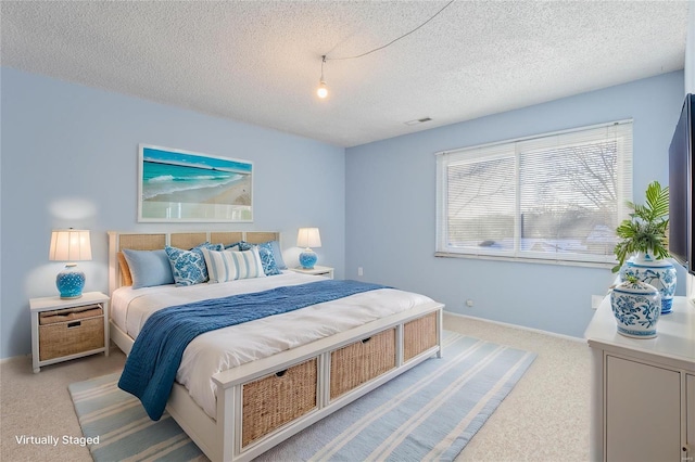 carpeted bedroom featuring a textured ceiling