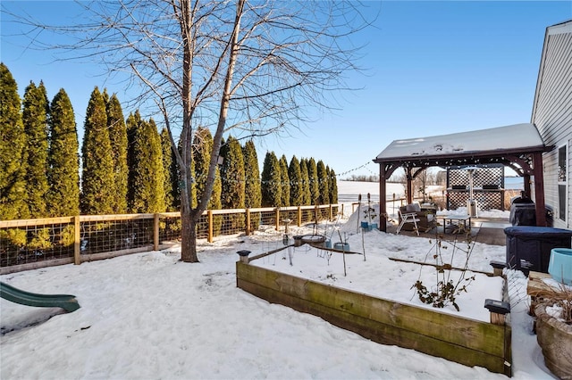 yard covered in snow featuring a gazebo