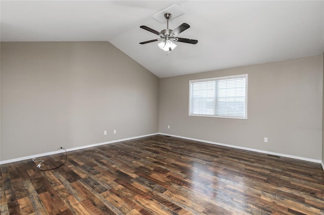 spare room featuring ceiling fan, dark wood-type flooring, and vaulted ceiling