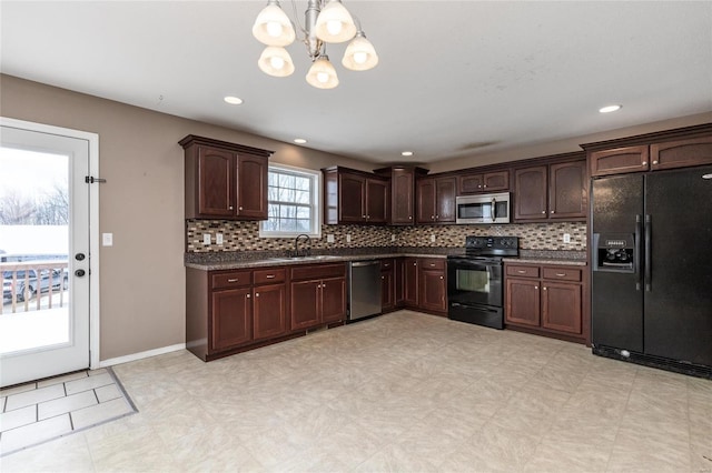 kitchen featuring black appliances, sink, hanging light fixtures, a notable chandelier, and dark brown cabinets