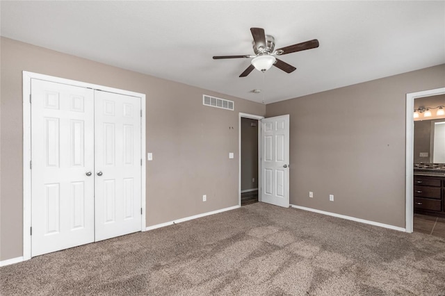 unfurnished bedroom featuring carpet flooring, connected bathroom, a closet, and ceiling fan