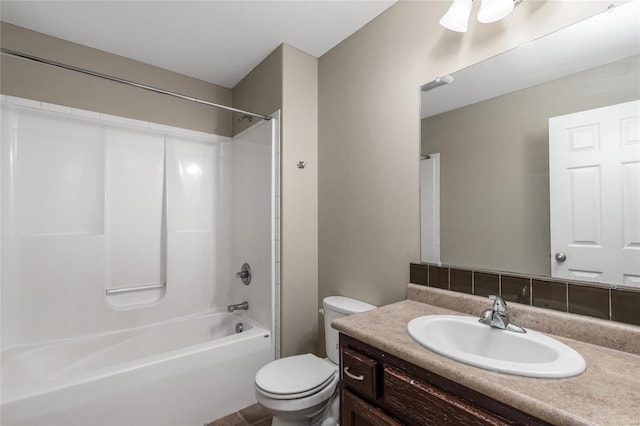 full bathroom with toilet, vanity, and washtub / shower combination