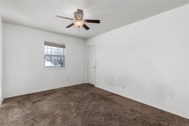 unfurnished room with ceiling fan and carpet