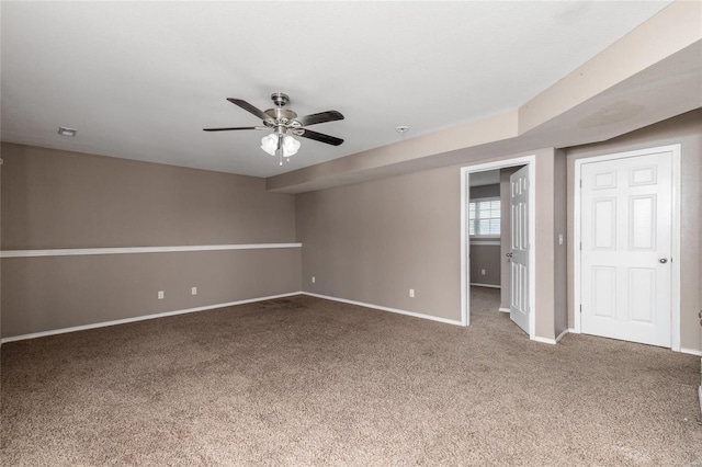 carpeted empty room featuring ceiling fan