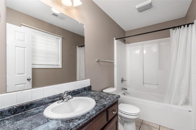 full bathroom featuring tile patterned floors, vanity, toilet, and shower / bath combo