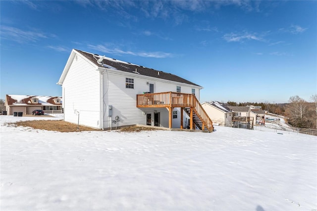 snow covered property featuring a deck