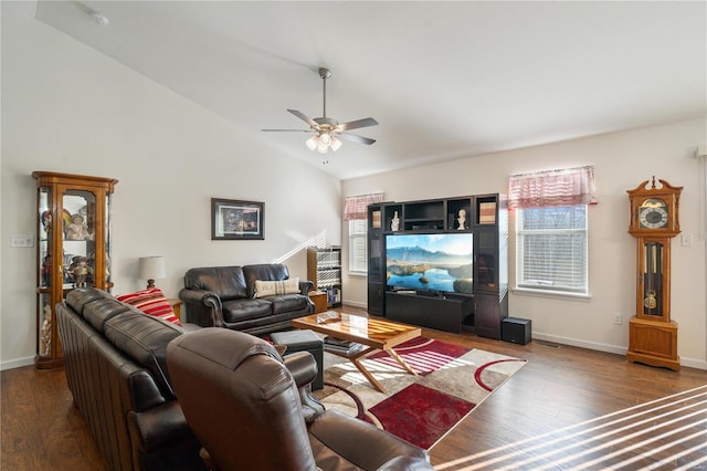 living room featuring vaulted ceiling, dark wood-type flooring, and ceiling fan