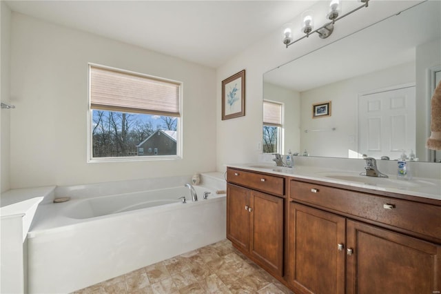 bathroom with vanity and a bathtub