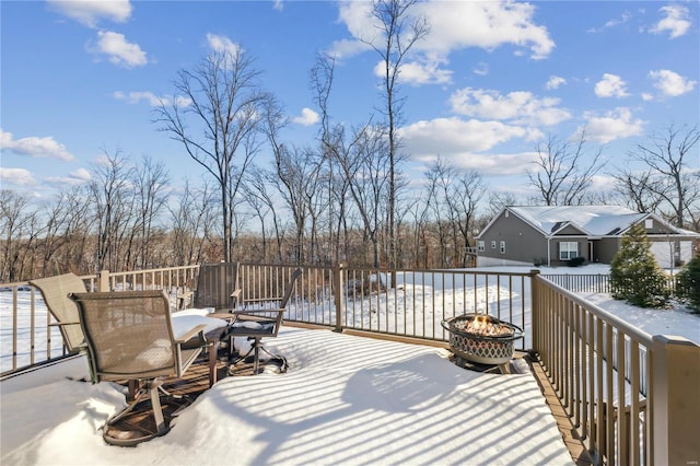 snow covered deck with an outdoor fire pit