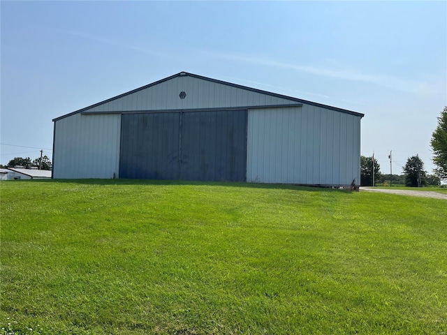 view of outbuilding featuring a lawn