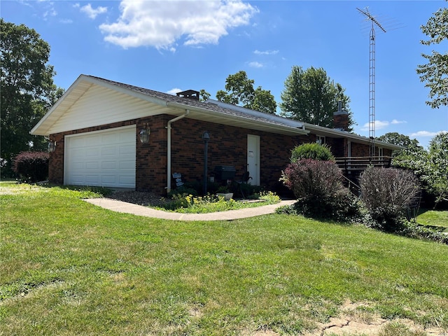 single story home featuring a garage and a front lawn