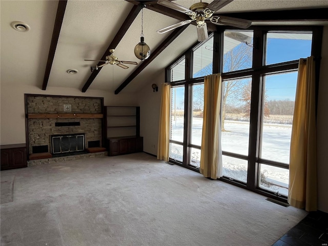 unfurnished living room with light colored carpet, ceiling fan, beam ceiling, high vaulted ceiling, and a fireplace