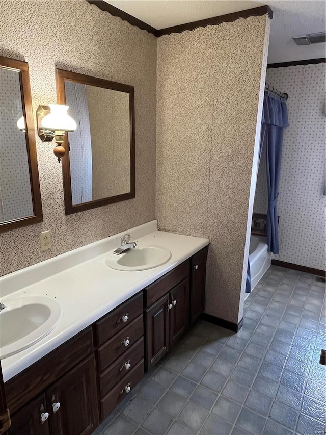 bathroom featuring tile patterned flooring, vanity, shower / tub combo with curtain, and ornamental molding