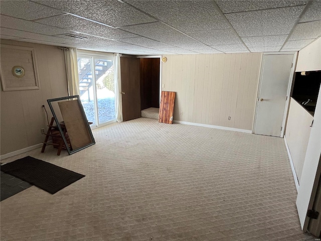 basement with wood walls and carpet