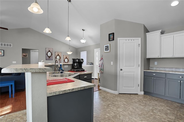 kitchen with sink, a center island with sink, and white cabinets