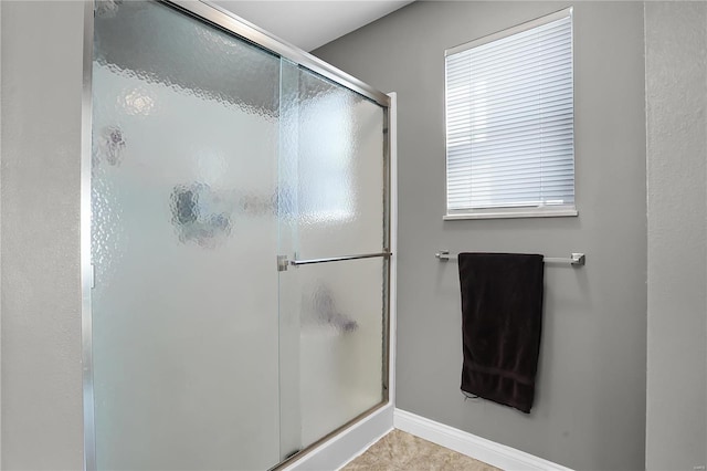 bathroom with tile patterned flooring and a shower with shower door