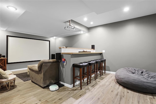 cinema featuring indoor bar and light wood-type flooring