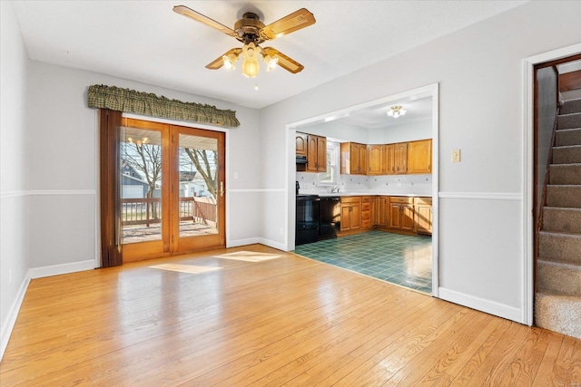 unfurnished living room featuring light hardwood / wood-style floors and ceiling fan