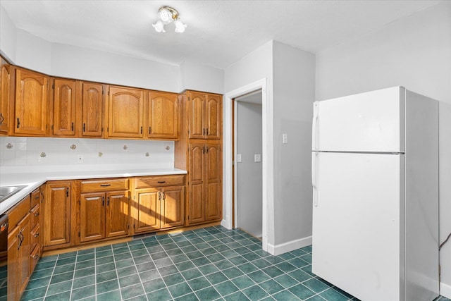 kitchen featuring tasteful backsplash, white fridge, and a textured ceiling