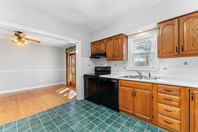 kitchen with dark hardwood / wood-style floors, sink, decorative backsplash, ceiling fan, and black appliances