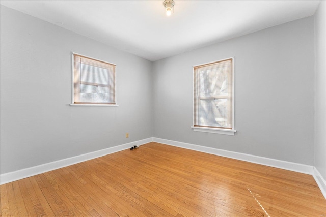 spare room featuring wood-type flooring