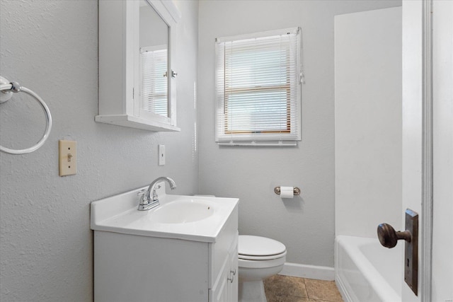 bathroom featuring tile patterned floors, vanity, and toilet