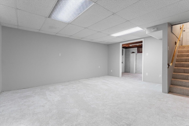 basement with carpet floors and a paneled ceiling