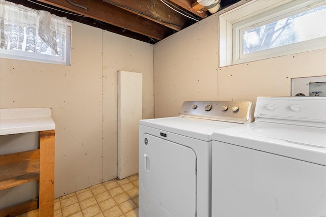 clothes washing area with separate washer and dryer