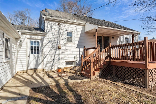 rear view of property featuring a deck