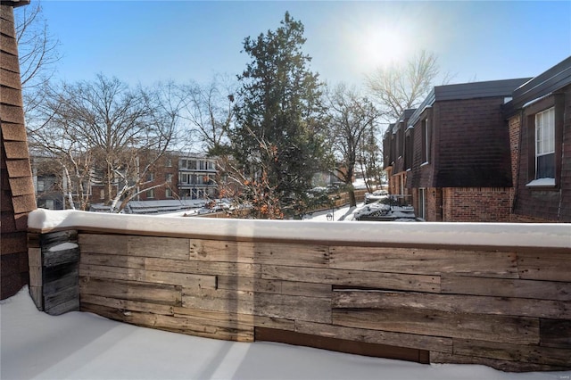 view of snow covered back of property