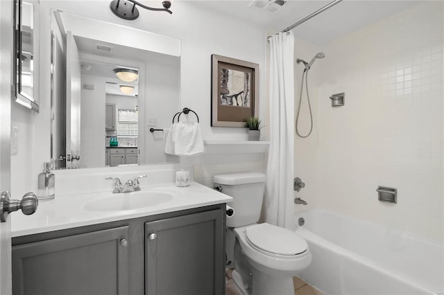 full bathroom with shower / tub combo with curtain, vanity, and toilet