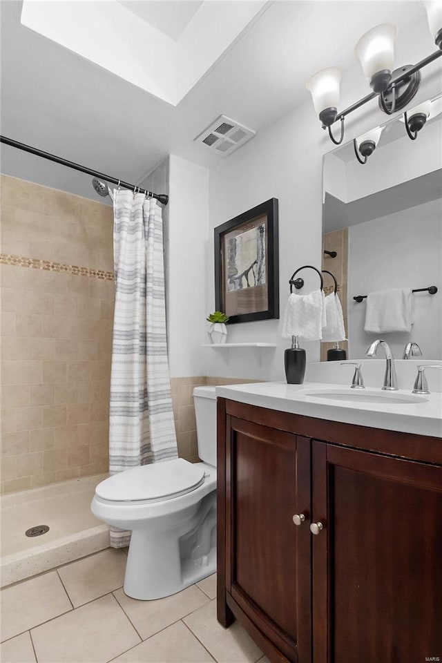 bathroom featuring tile patterned floors, vanity, a shower with shower curtain, and toilet