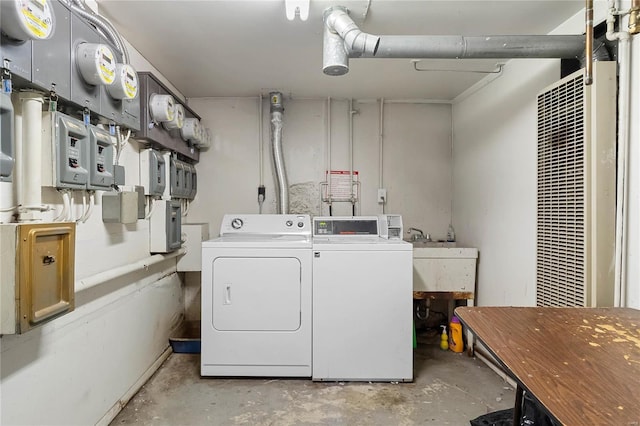 clothes washing area with sink and washer and dryer