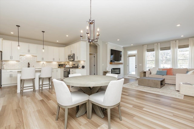 dining space featuring a chandelier and light hardwood / wood-style flooring