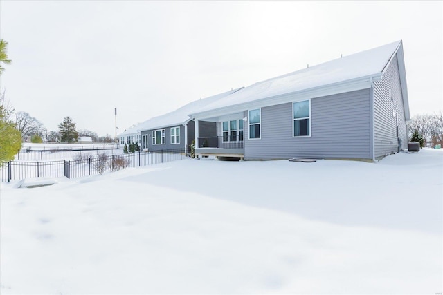 view of snow covered rear of property