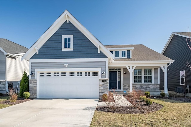 craftsman-style house featuring a garage, stone siding, driveway, and a shingled roof