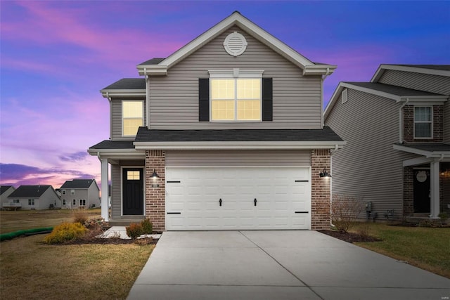 view of front property with a garage and a lawn