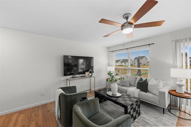 living room featuring ceiling fan and light hardwood / wood-style floors