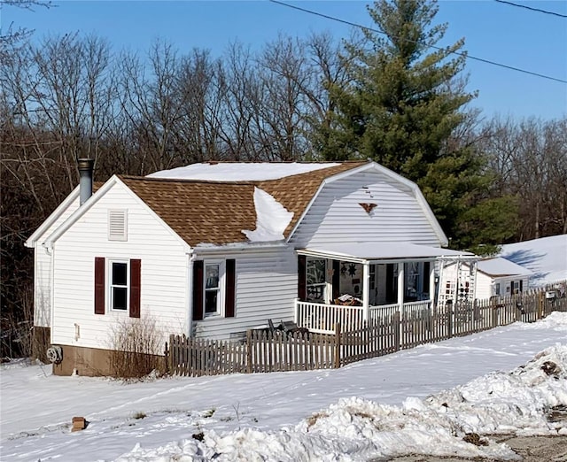 view of snow covered back of property