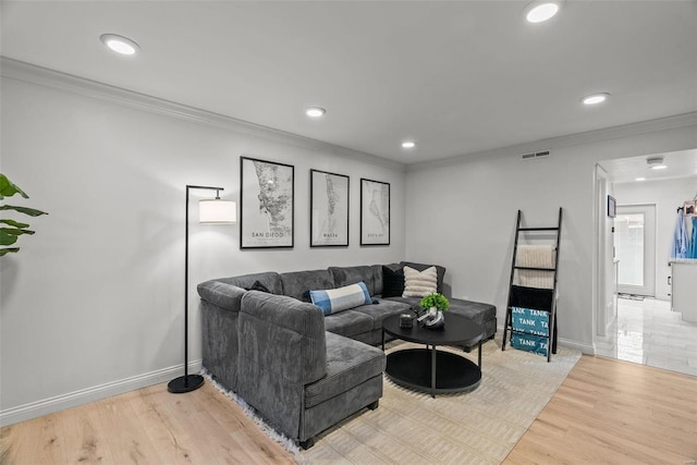 living room featuring light wood-type flooring and ornamental molding